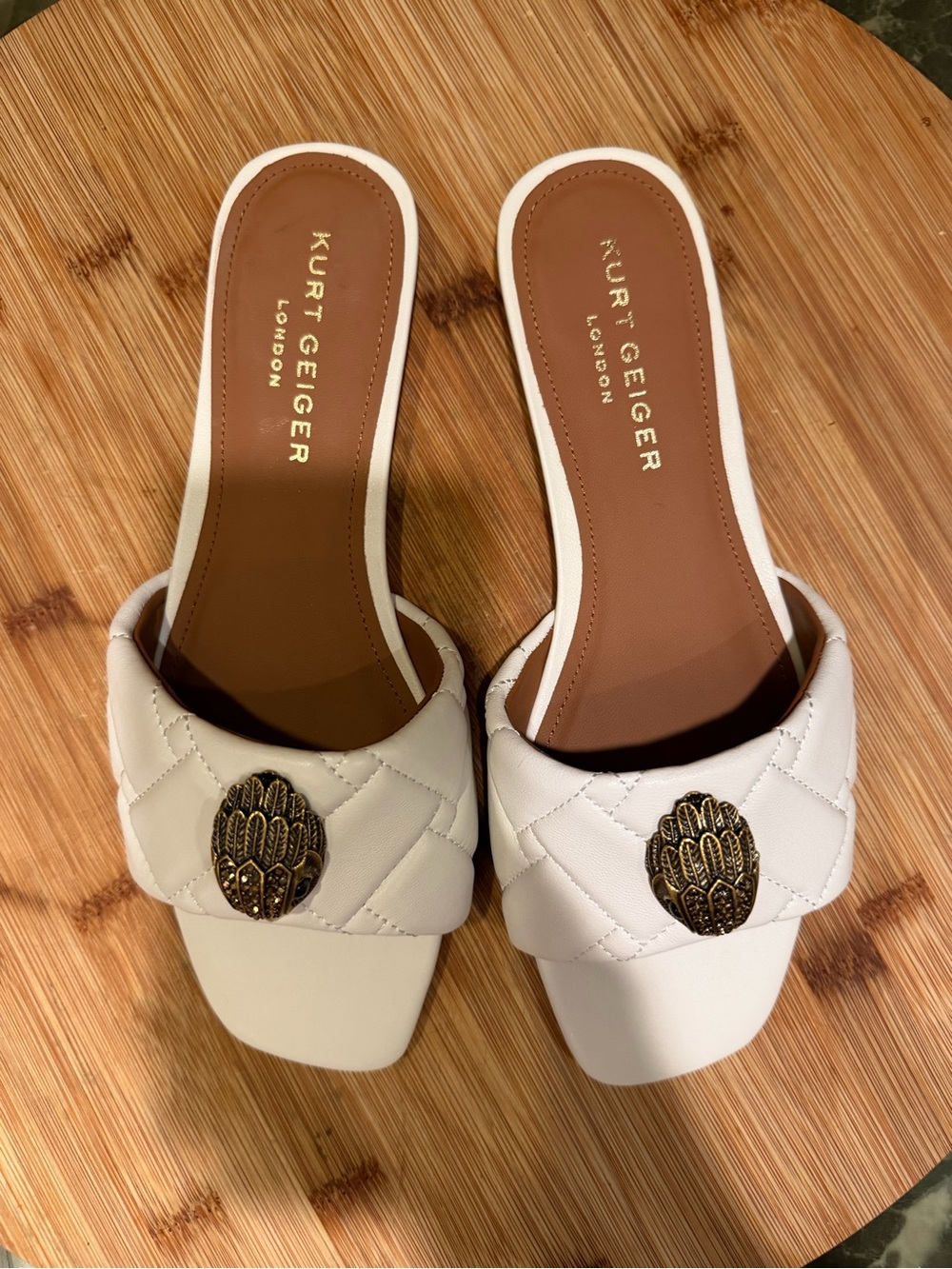 Kurt Geiger Cream Quilted Slide Mules with Gold Emblem